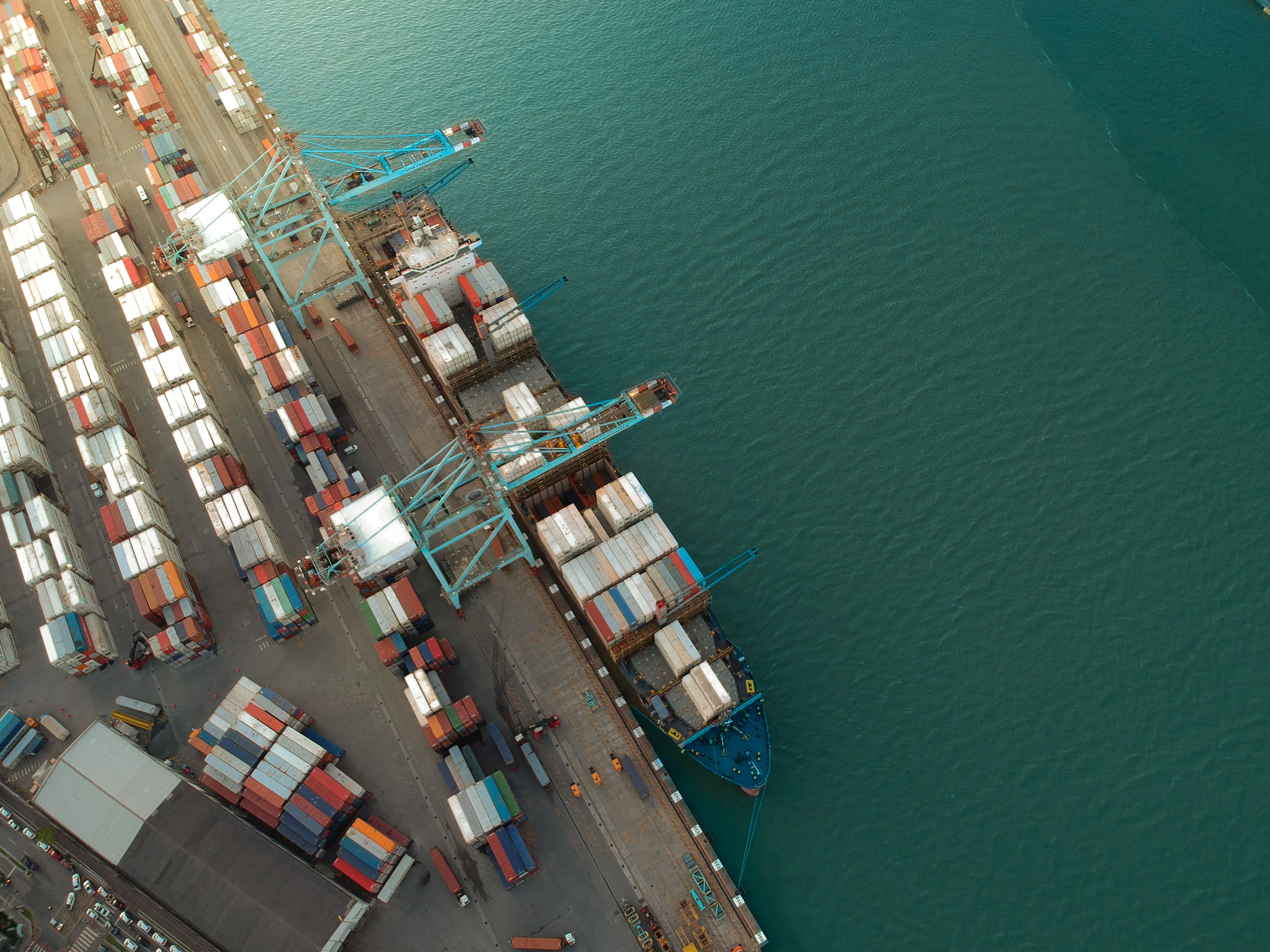 Container ship at port with large cranes